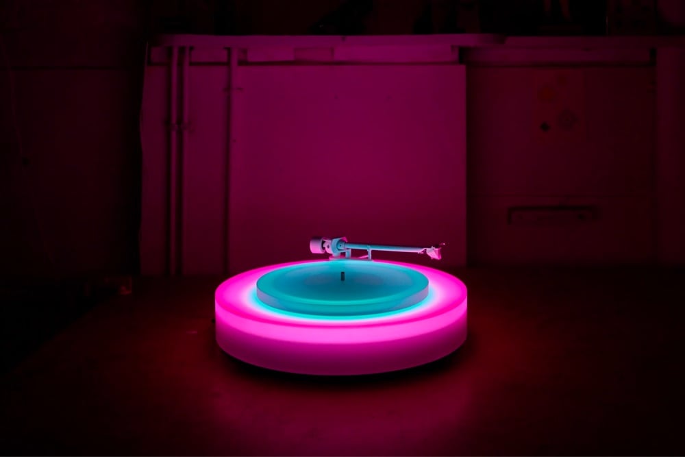 a turntable glowing in a dark room