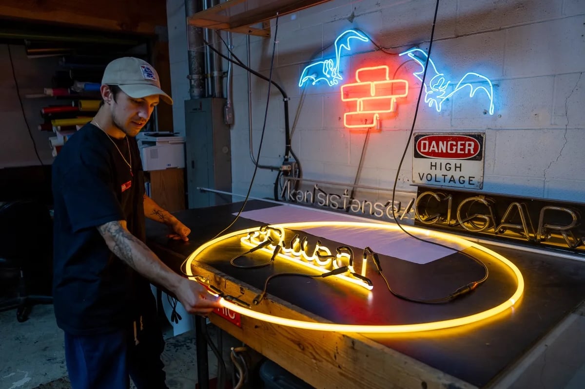 a man crafts a circular neon sign