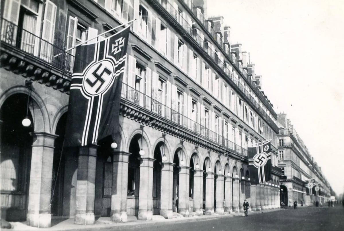 A photograph of Paris' Le Meurice hotel in Rue de Rivoli flanked by the flags of Nazi Germany