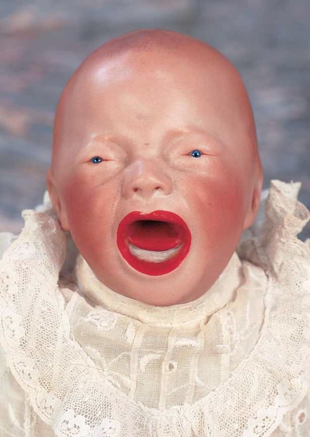 a creepy looking screaming doll