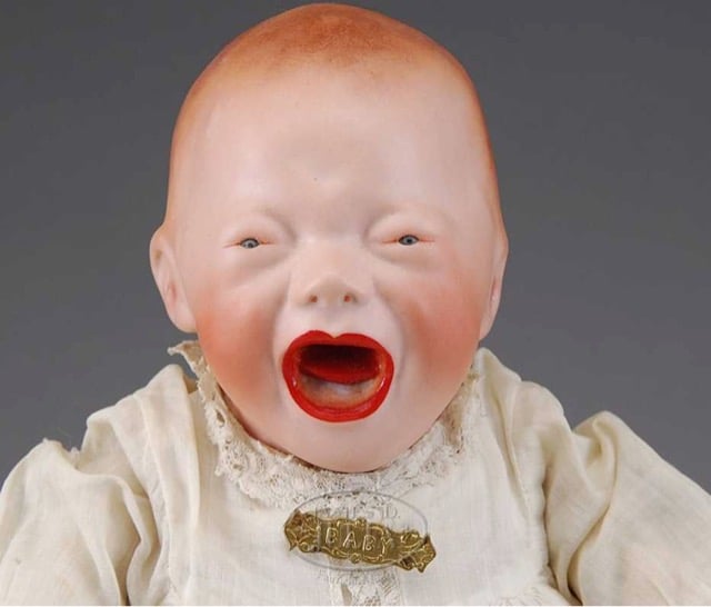 a creepy looking screaming doll