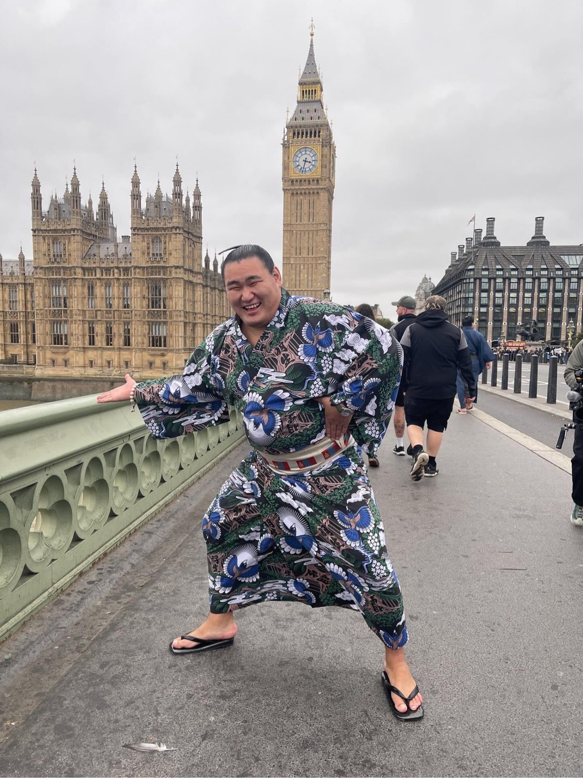 a sumo wrestler posing in front of Big Ben