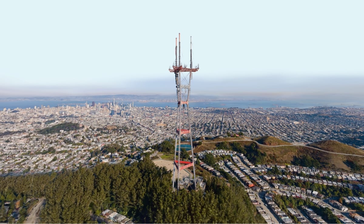 a large tower stands tall over the city of San Francisco