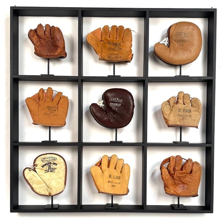 a collection of vintage baseball mitts