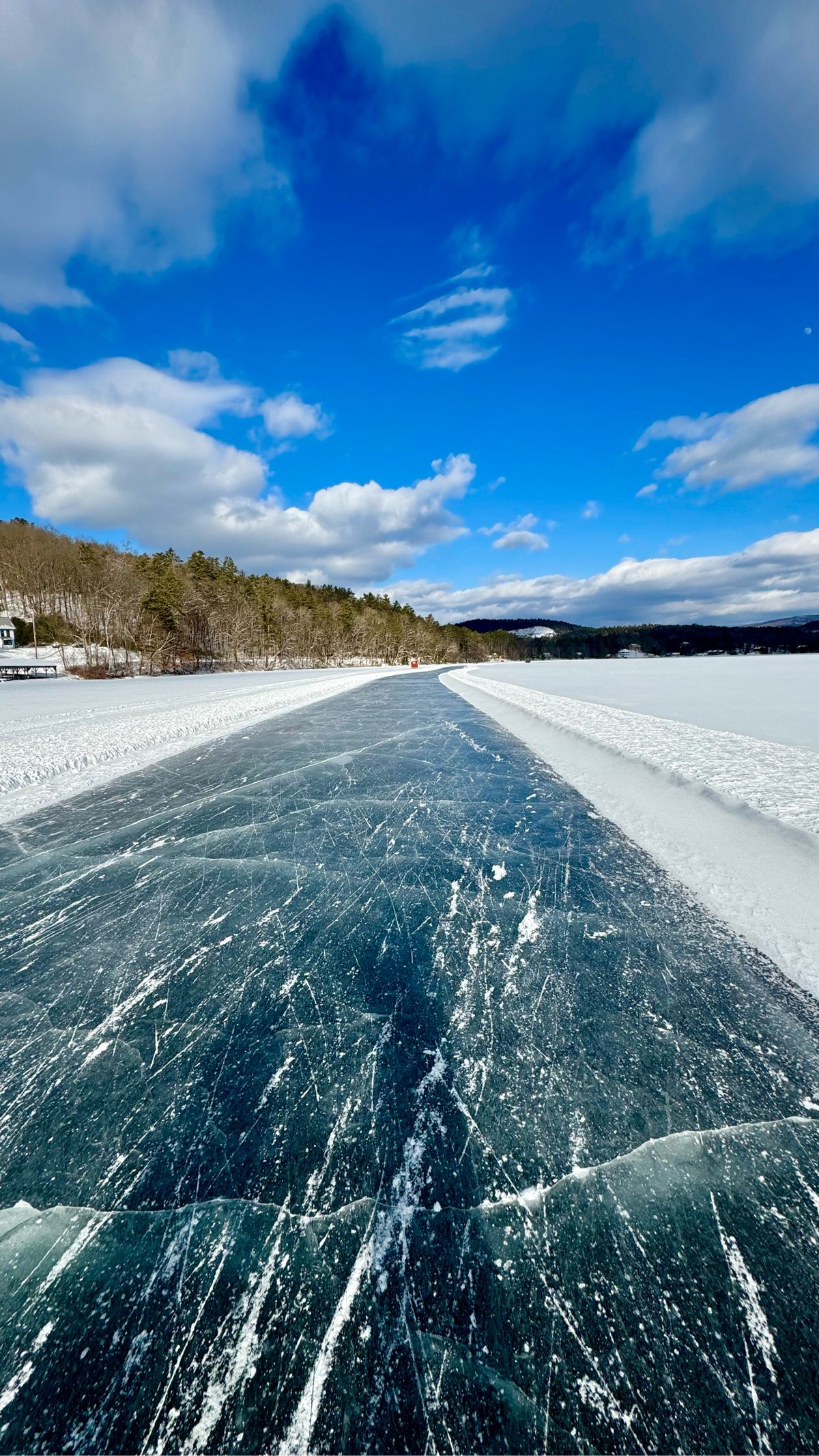 a frozen path on a snowy lake