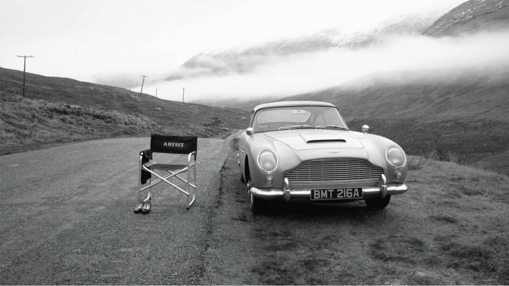 an empty chair next to a James Bond sportscar