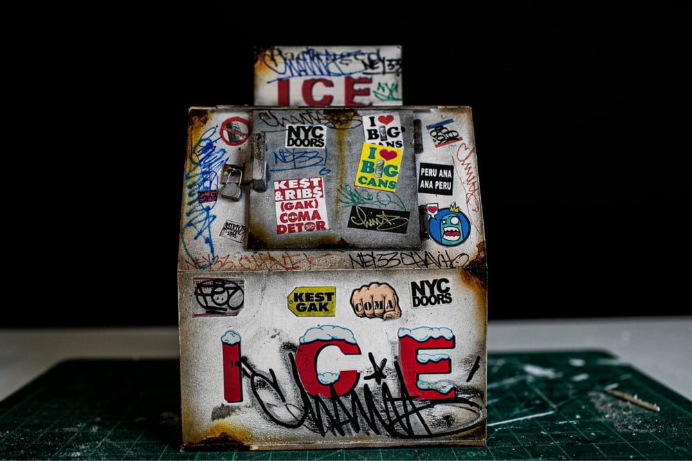 miniature ice machine covered with stickers and grafitti