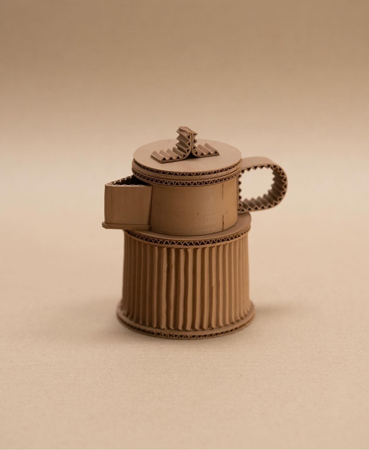 ceramic teapot that looks like it's made out of cardboard