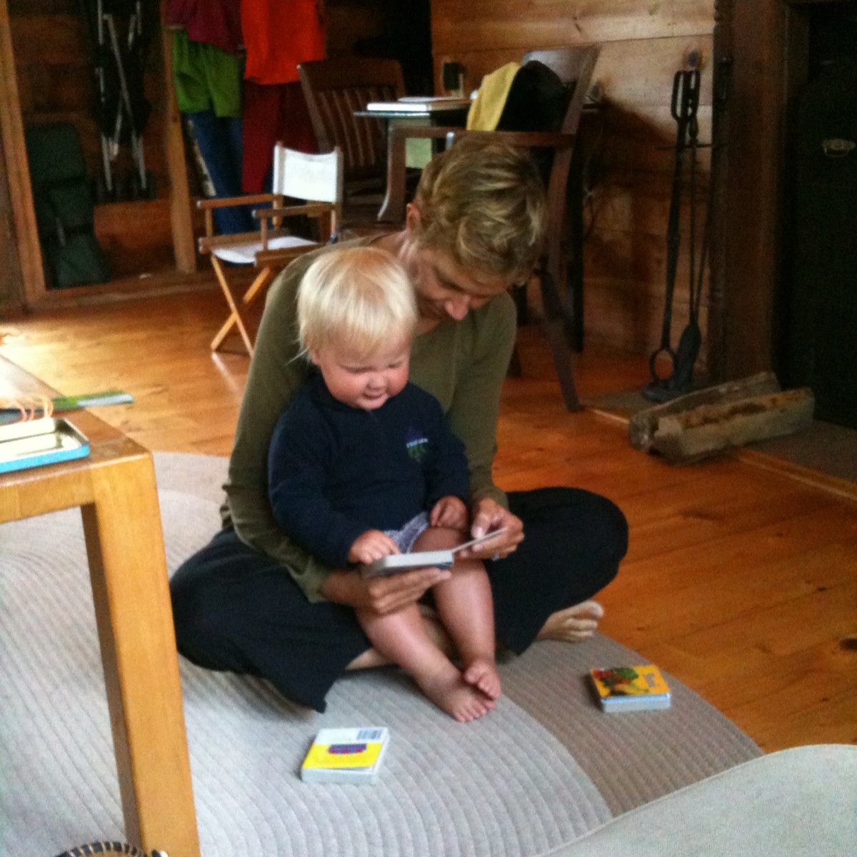 Meg reading a board book to our daughter Minna, who is sitting in her lap