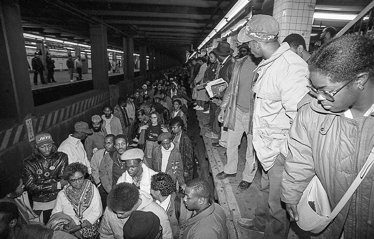 protesters stand on the tracks at a NYC subways stop