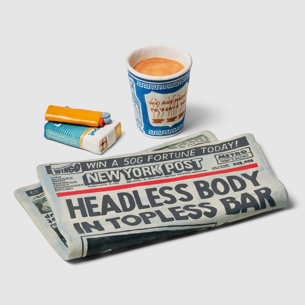 ceramic pottery of a newspaper, cigarettes, and a coffee cup