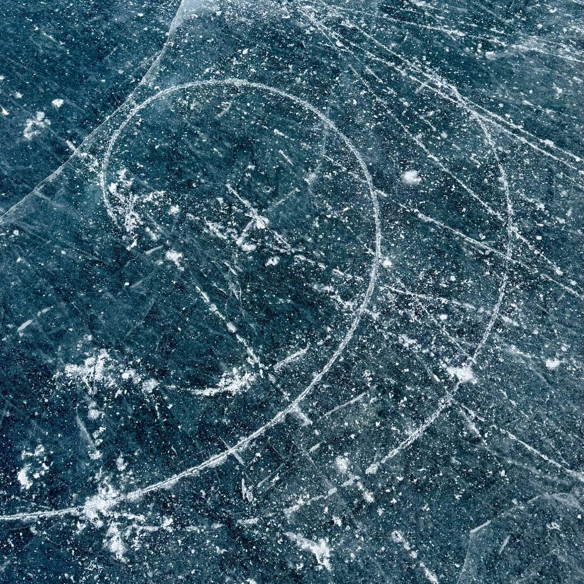 lake ice with cracks and a spiral pattern