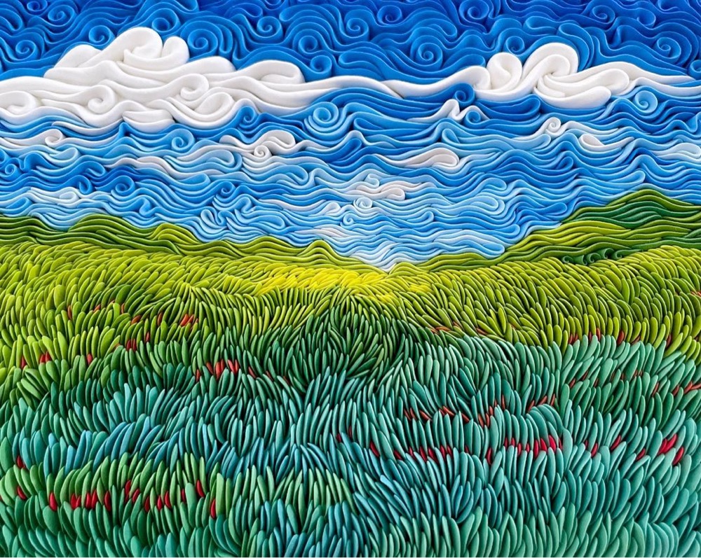 a blue sky and green field landscape sculpted from clay