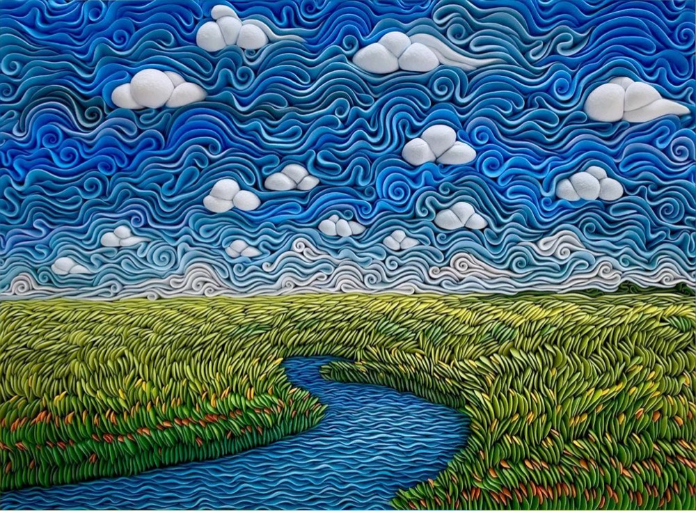 a blue sky, green field, and river landscape sculpted from clay