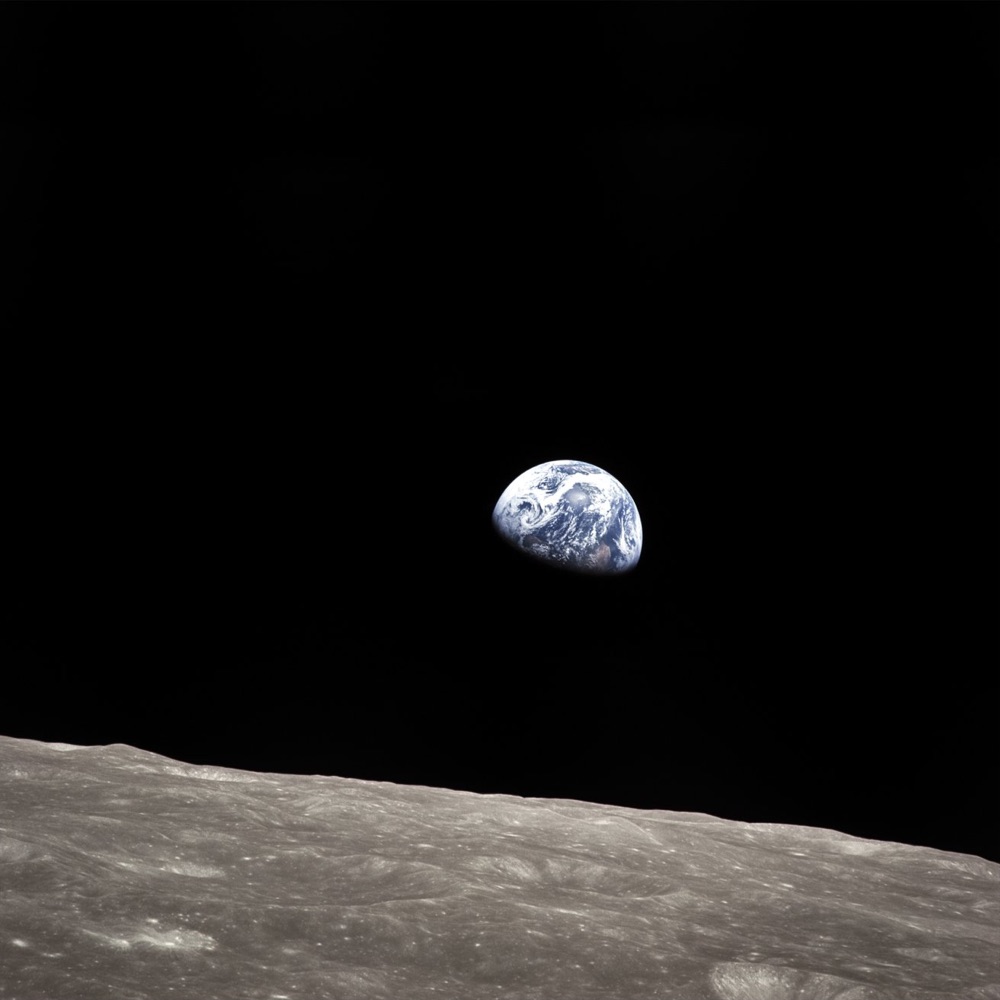 Earth rising over the surface of the Moon