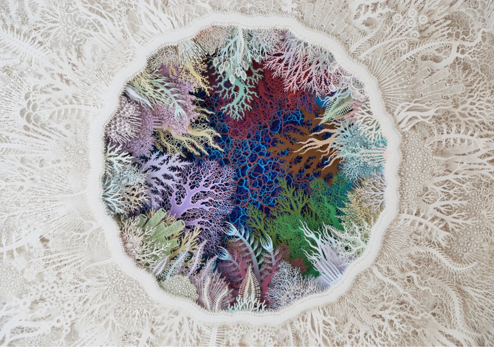 intricate paper sculpture of bleached corals