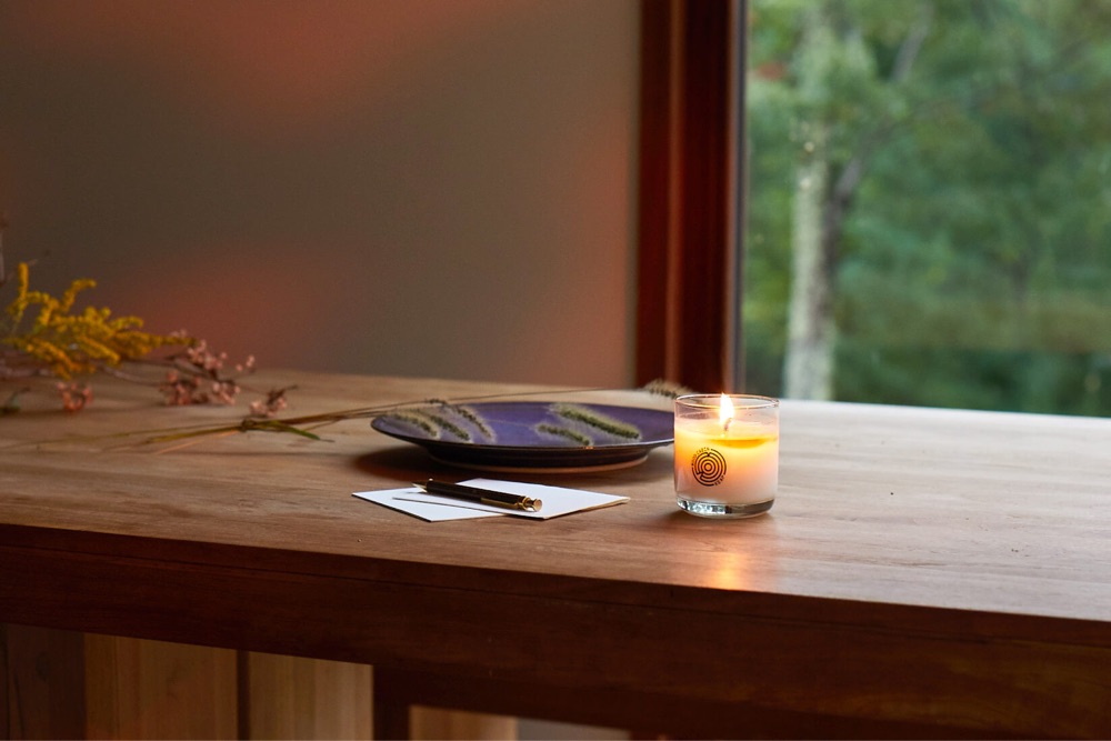 a lit Keap candle on a table