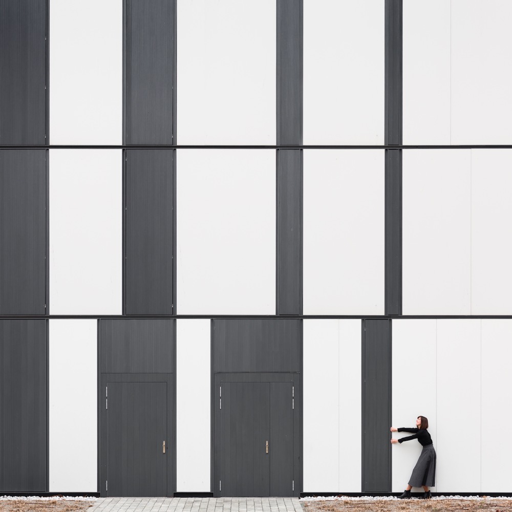 a woman appears to be pulling an architectural element across a wall