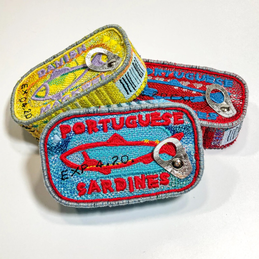 embroidered sculpture of sardine tins