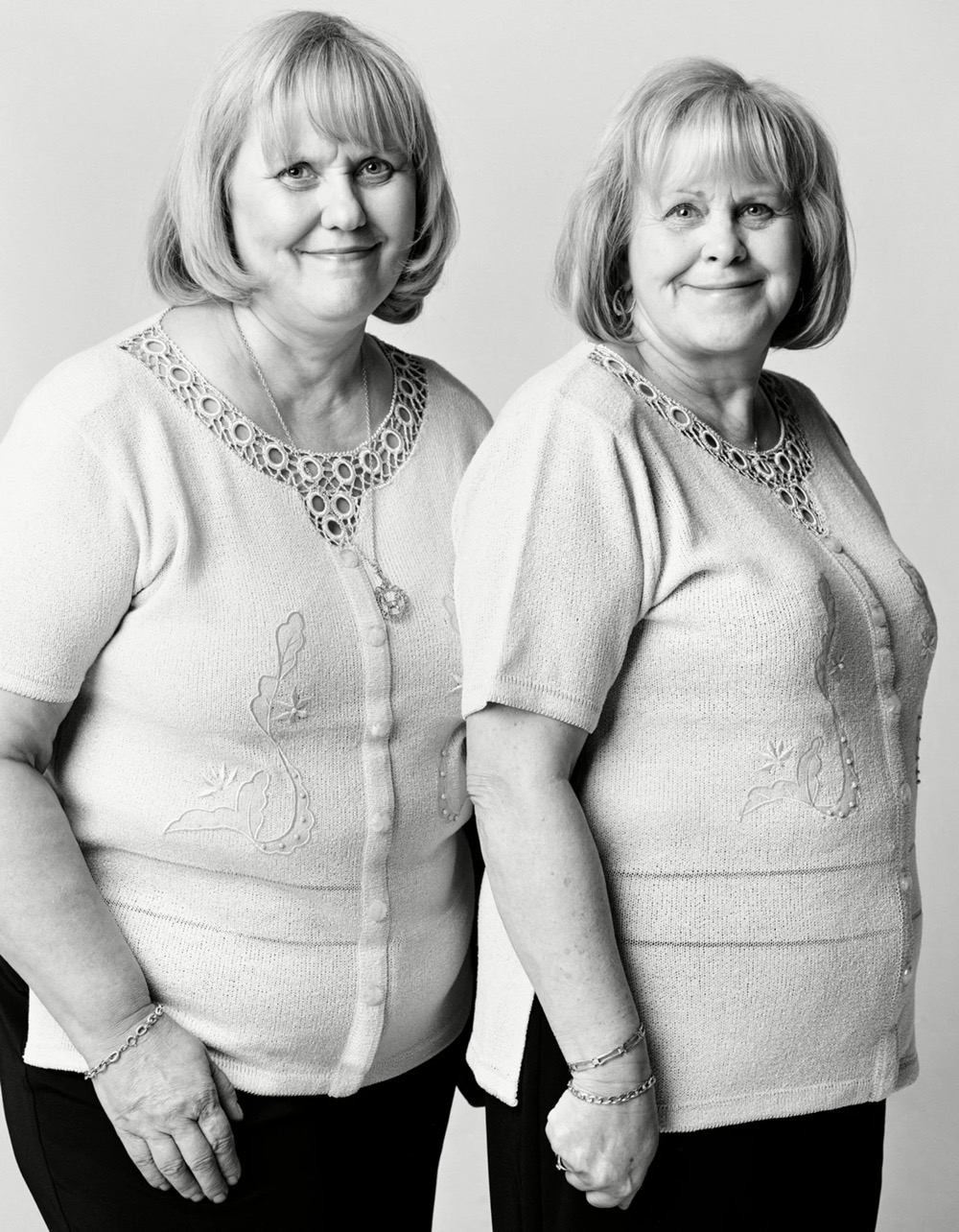 black & white photo of two unrelated people who look alike