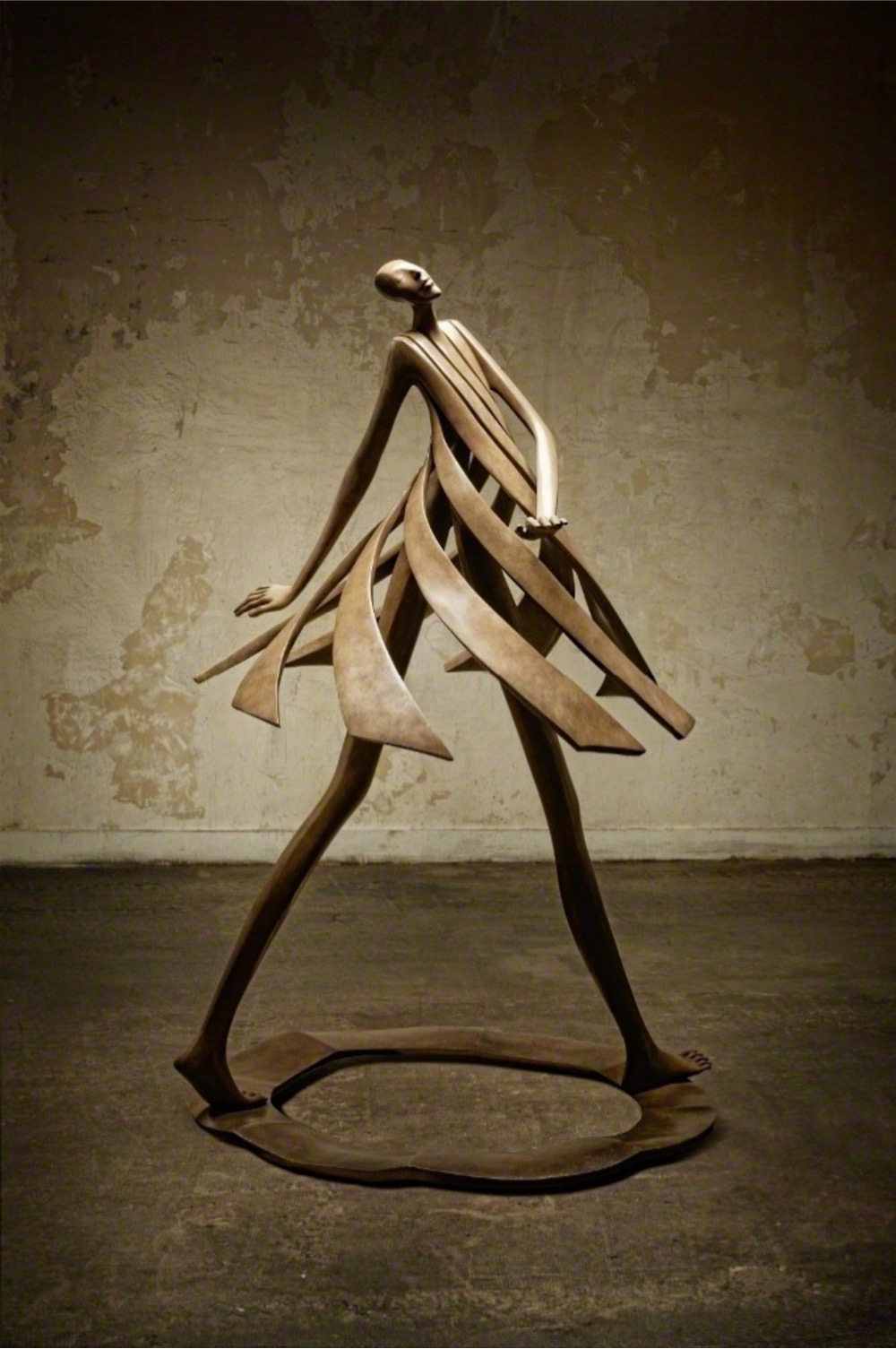 sculpture of a woman walking, her dress flaring out