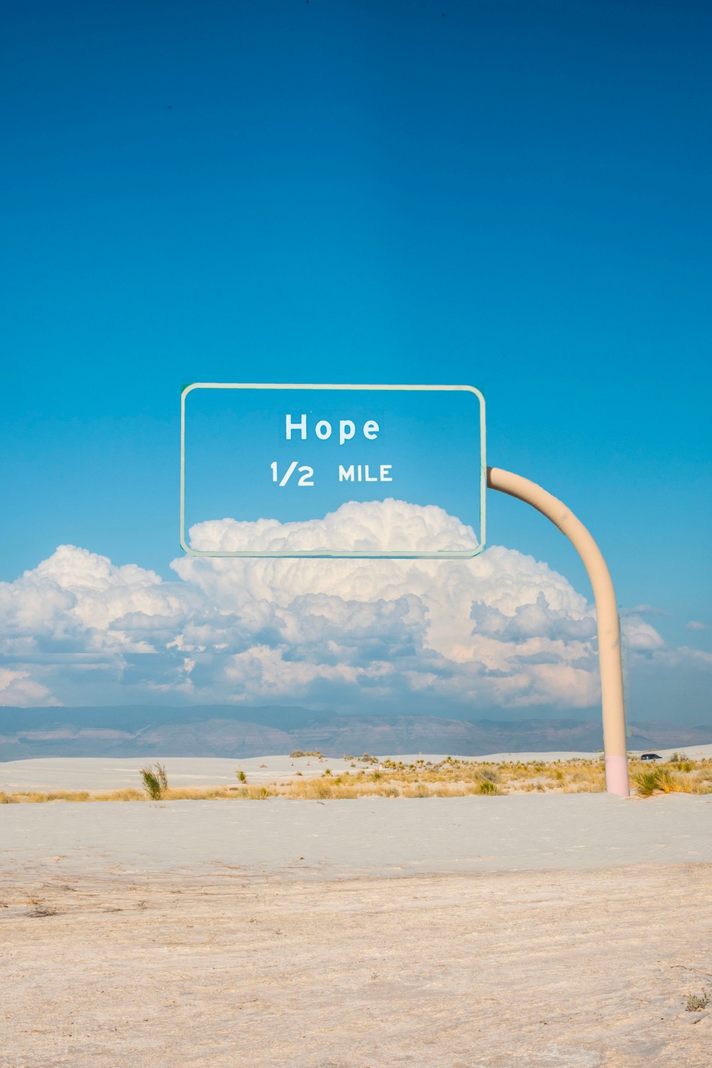 a transparent road sign says 'Hope 1/2 Mile'