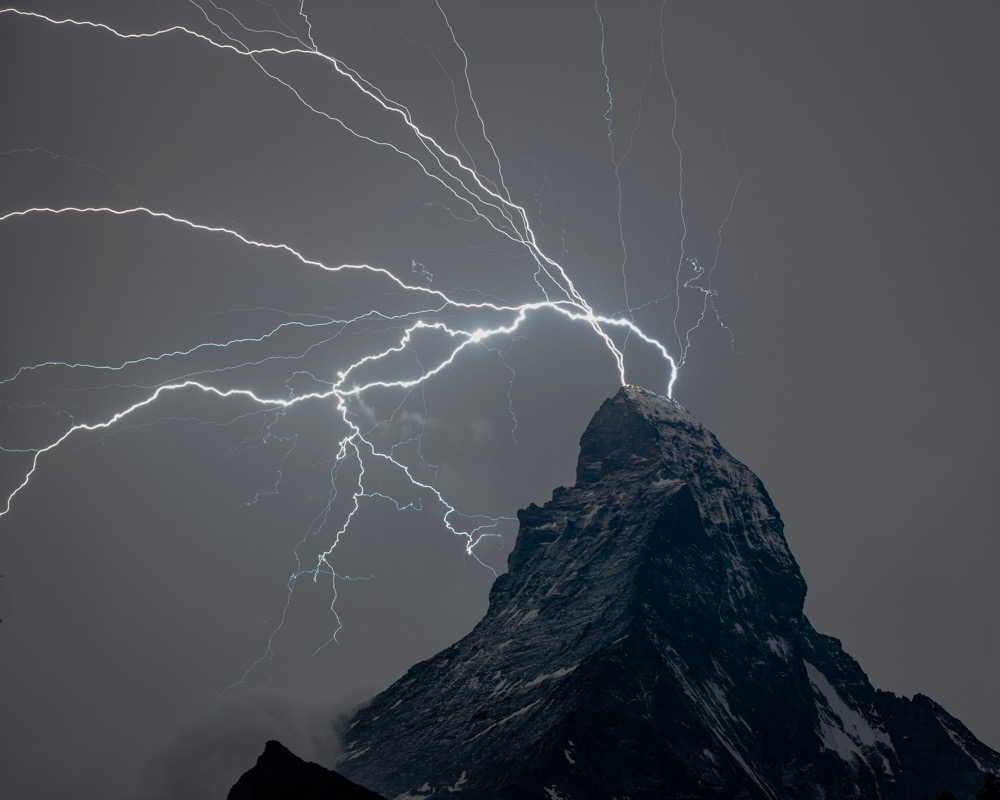 lightning striking the top of a mountain