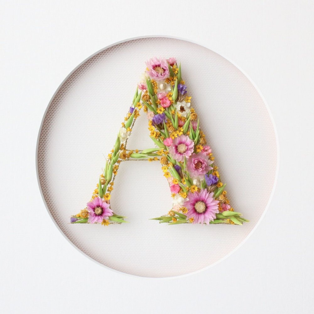 dried flowers arranged in the shape of the letter A