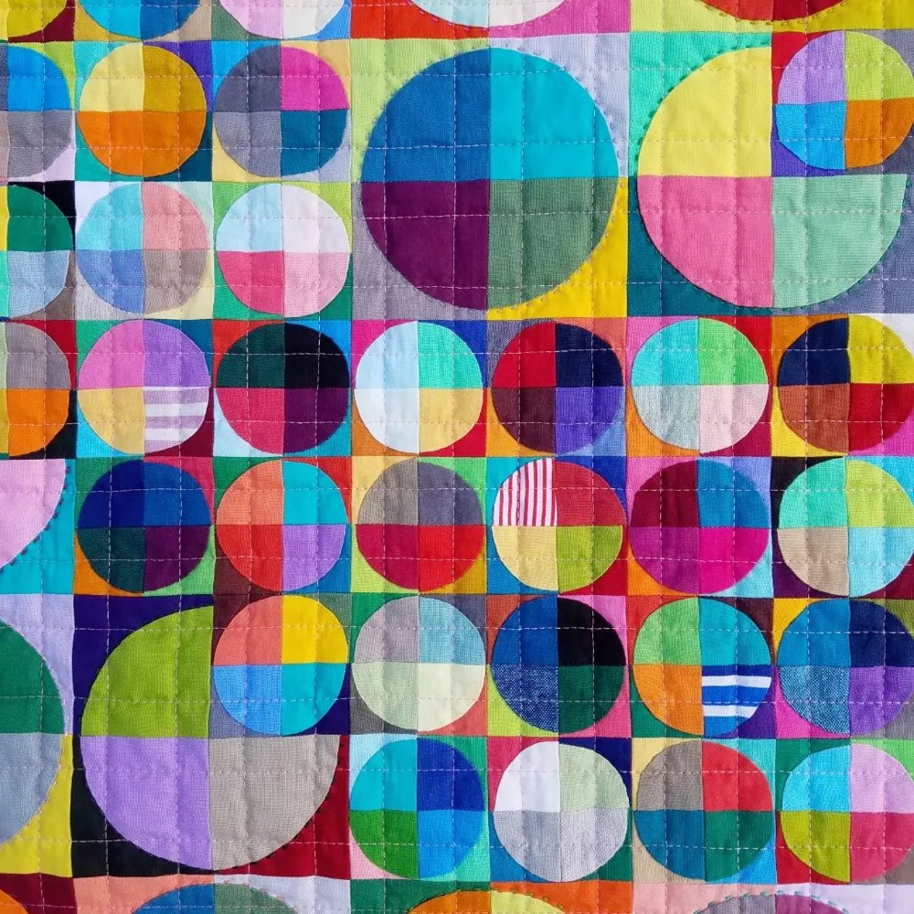closeup of a quilt with a circular pattern
