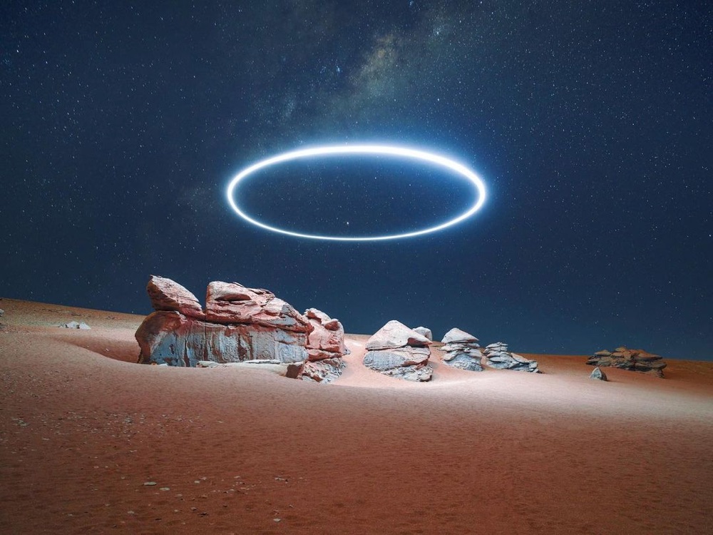 a bright circle of light over a rocky desert landscape