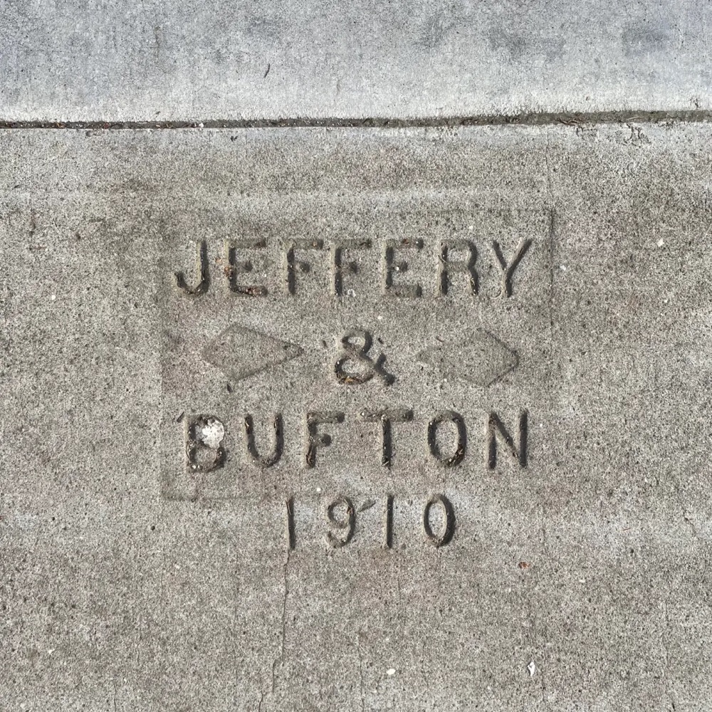 a sidewalk stamps that reads 'Jeffrey & Bufton 1910'